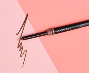 A pinkish nude Mary Kay lip liner is photographed with its cap off, atop a two-toned pink background and alongside a product smear.