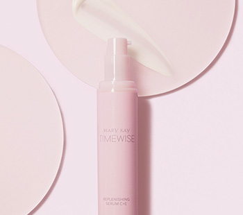 Uncapped bottle of Mary Kay TimeWise Replenishing Serum C+E and product rub on separate clear discs
