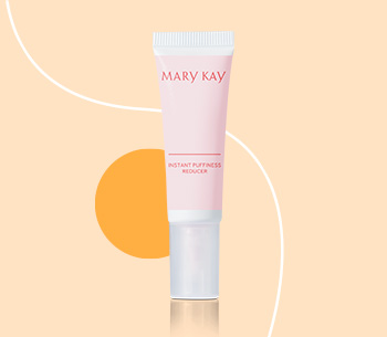 Mary Kay Instant Puffiness Reducer in front dark orange circle and white line