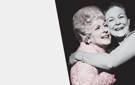 Mary Kay Ash embraces a member of the Mary Kay Independent Sales Force in a warm hug both as women smile.