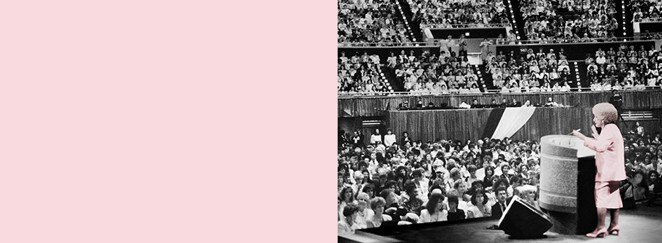 Mary Kay Ash stands at a podium in front of thousands of women at Mary Kay’s annual Seminar, a gathering of the independent sales force.